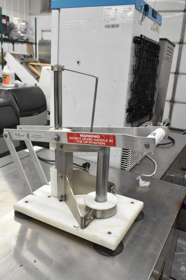 E-Z Cut II Metal Countertop Pineapple Corer in good condition with stainless steel components, mounted on a sturdy base.
