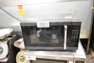 Hamilton Beach HB8436193153-03 countertop microwave oven, 2024 model, black, control panel visible, 120 volts, 1 phase.