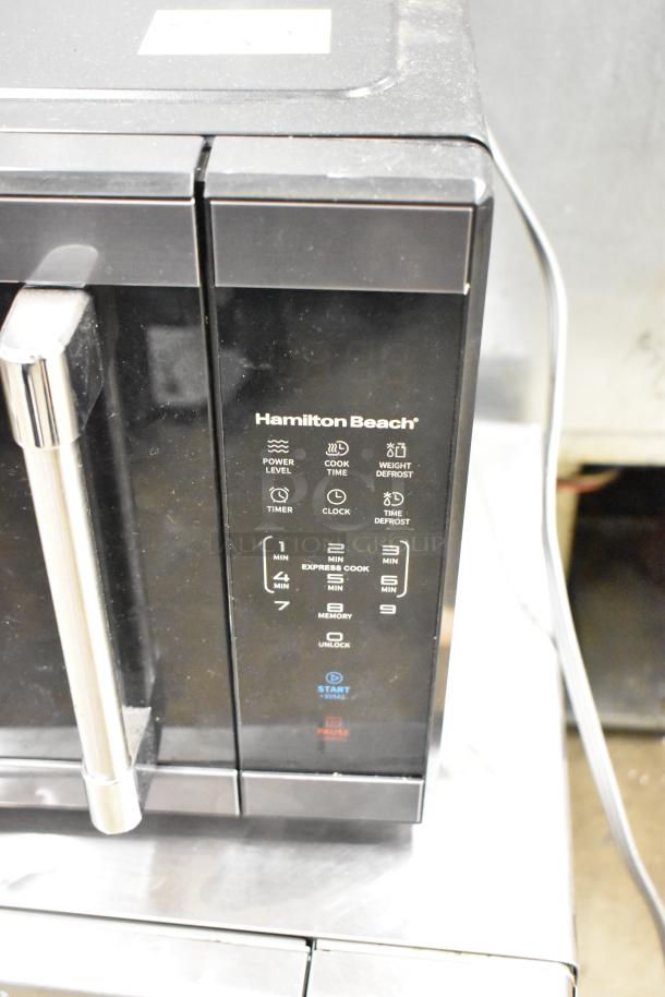 Hamilton Beach HB8436193153-03 countertop microwave, black, with control panel. Features 120 volts, 1-phase power. Model marked.