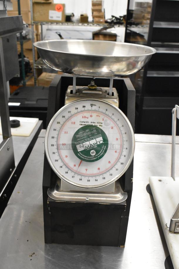 Two metal countertop scales, Yamato SM(N) and Marco SW10211. Features large dials, stainless steel bowls, and weight indicators.