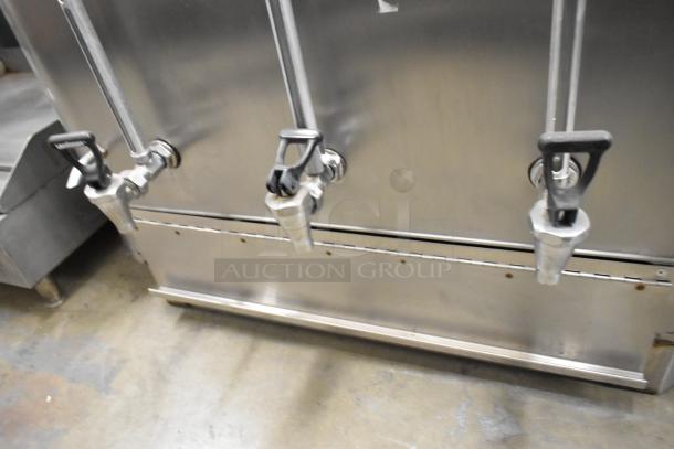 Stainless steel commercial countertop double automatic coffee urn with dual spouts and metal finish in good condition.