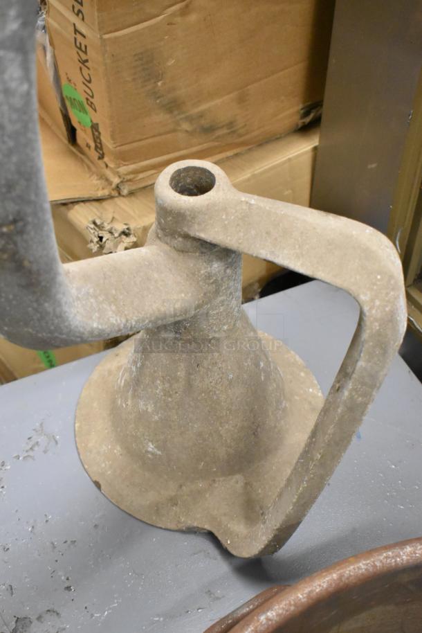 Dough hook attachment for Hobart mixer, metal, worn condition, shown on a table.