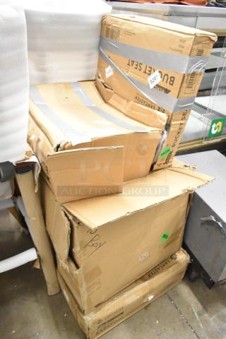 Stack of damaged boxes labeled "Lancaster Table & Seating." Contains black bucket seat and beige barstool cushions.
