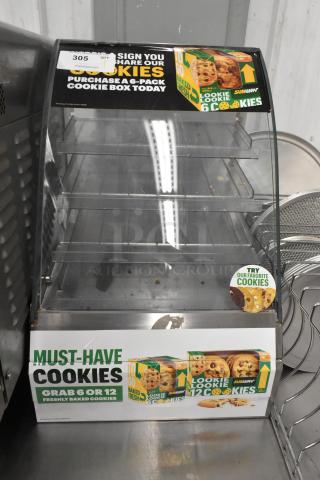 Nemco 69700A Metal Countertop Dry Cookie Merchandiser Case, featuring multiple shelves, promotional cookie graphics. Signs of use.