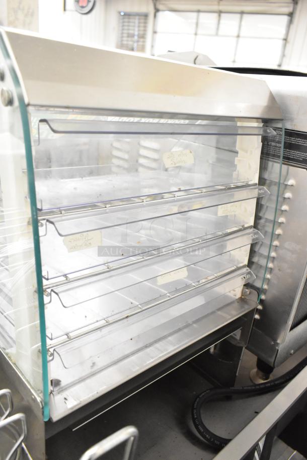 Nemco 69700A Metal Countertop Dry Cookie Merchandiser Case with glass front, metal shelves, and visible product labels.