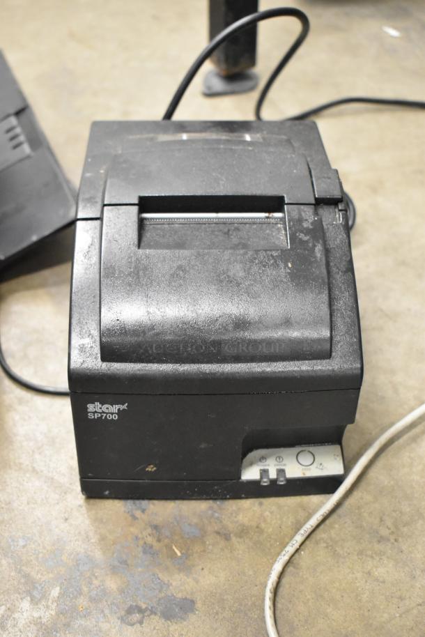 Star SP700 receipt printer in used condition. Features front control panel, power cord attached. Ideal for point-of-sale systems.