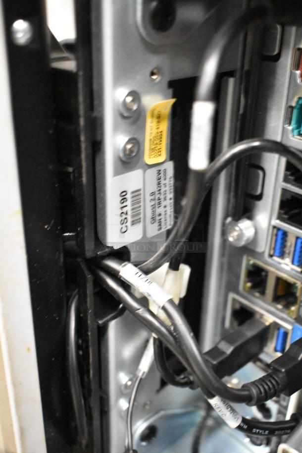 Rear view of Par POS Monitor showing cable connections and labels. Tags display model details. Ports for peripheral devices visible.