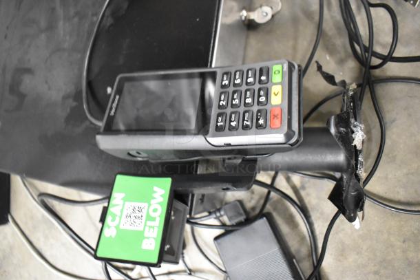 POS system with credit card reader, green "SCAN BELOW" sign, cables, and parts of a Par POS monitor setup. Some wear visible.