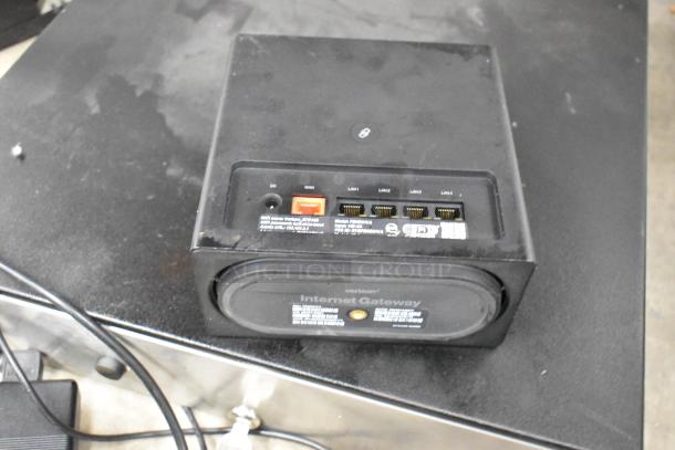 Verizon gateway device with multiple LAN ports, power input, and visible labels, suitable for internet connectivity.