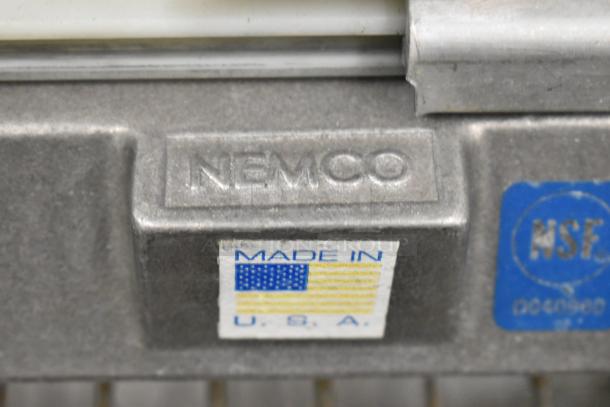 Nemco metal countertop tomato slicer, stamped logo, NSF certified, made in USA label, durable condition.