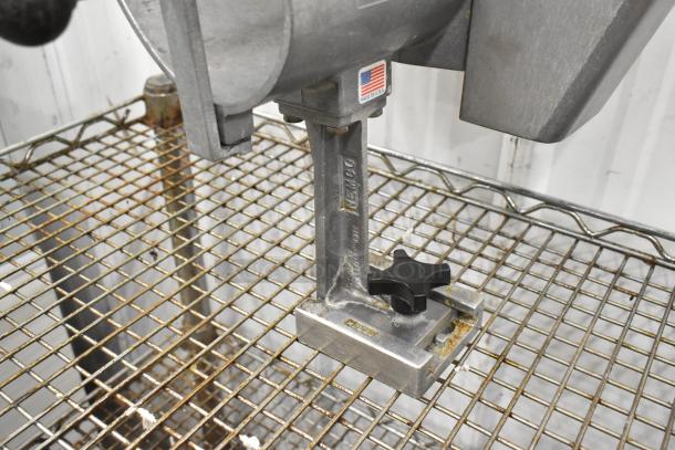 Nemco Metal Countertop Vegetable Slicer, stainless steel, made in USA, visible wear, attached to wire grate shelving.