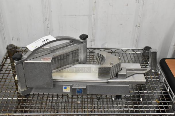 Nemco 56600 Metal Countertop Tomato Slicer, in good condition, with sharp blades and a sturdy handle, visible caution label.