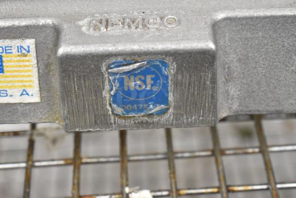 Nemco 56600 metal countertop tomato slicer, visible NSF certification label, used condition, made in USA marking.