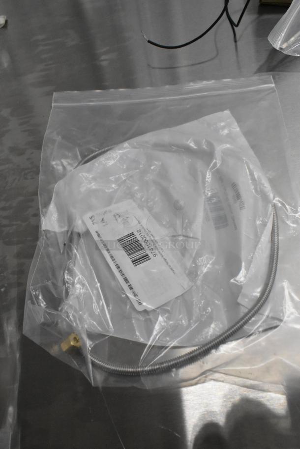 Plastic bag containing a stainless steel flexible tube with visible barcode label, item number 9741000018.