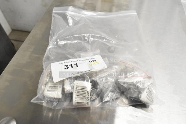 Bag of 8 brand new scratch and dent items, including American Range A17010 grate and Imperial Range 40499 pilot tube/tip kit. Tags show "Qty VX8" and item number 311.