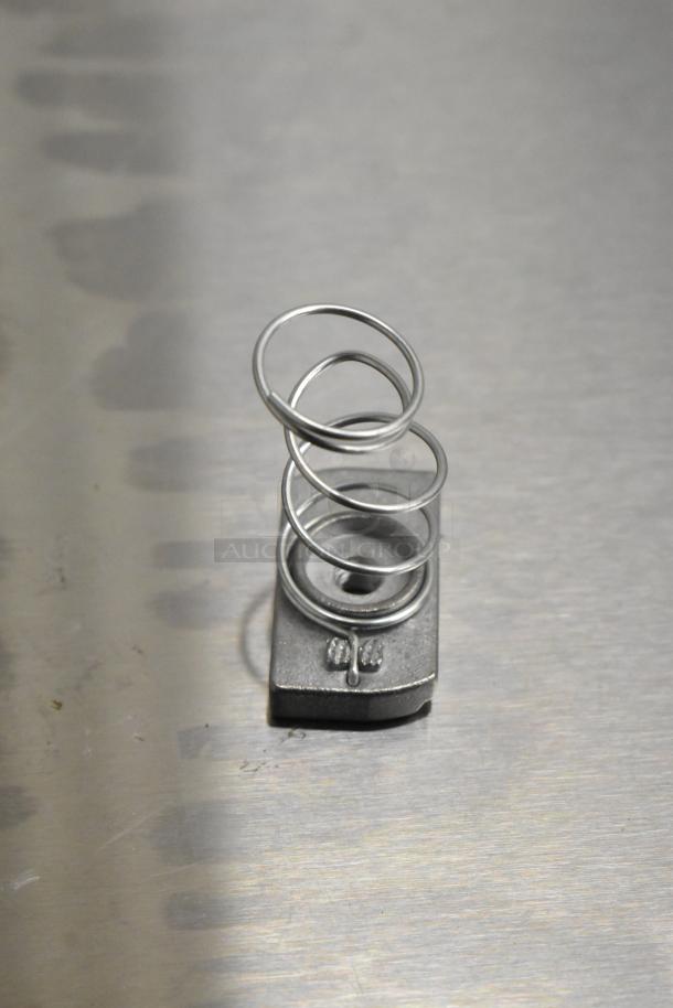 Steel coil spring with a rectangular metal base, part of a new scratch and dent auction lot including American and Imperial Range items.