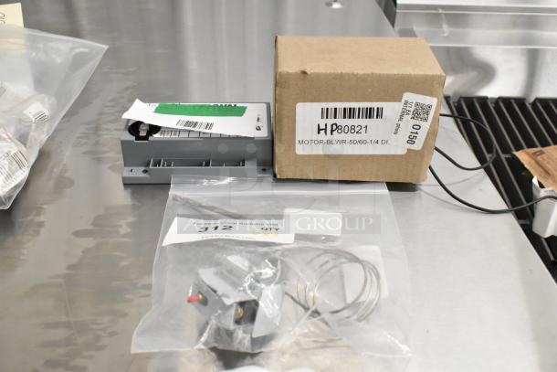 3 new Henny Penny parts: 77285 High Limit, 77839 Ignition Module, 80821 Blower Motor. Box includes labels with part numbers.