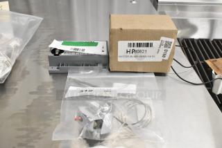 3 new Henny Penny parts: 77285 High Limit, 77839 Ignition Module, 80821 Blower Motor. Box includes labels with part numbers.