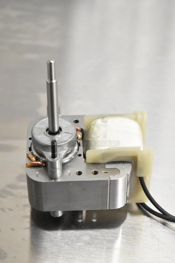 Brand new Henny Penny 80821 blower motor HP80821, showing metal housing and wiring, on reflective surface.