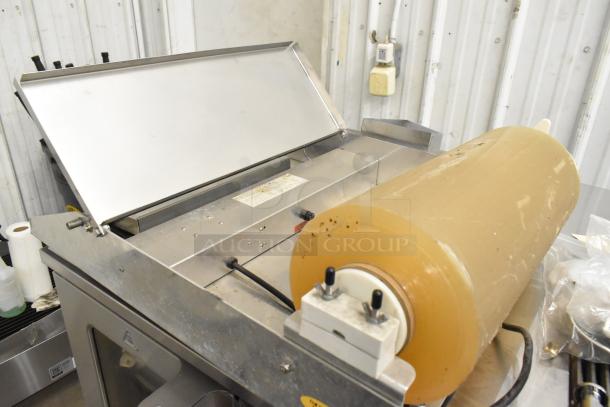 2016 Metal Countertop Wrapping Station, model 5000156, 115V, 1 Phase, excellent condition, roll of wrapping film included.