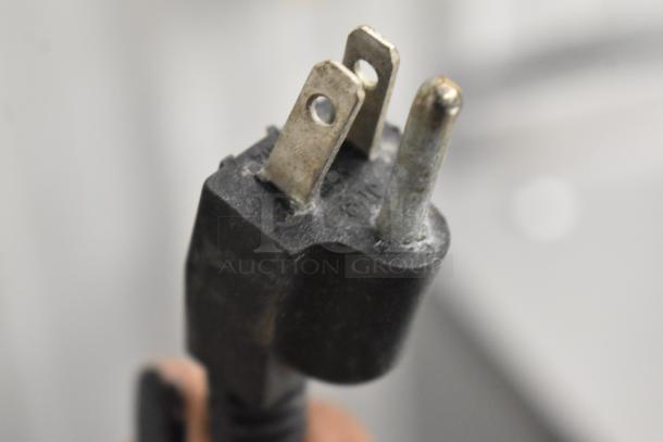 Close-up of a plug for the 2016 Metal Countertop Wrapping Station, model 5000156, 115 volts, 1 phase.