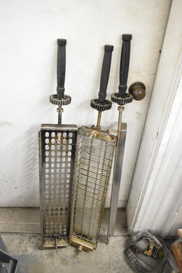 12 metal basket skewers for rotisserie oven with handles and gear mechanisms. Good condition, ideal for grilling.