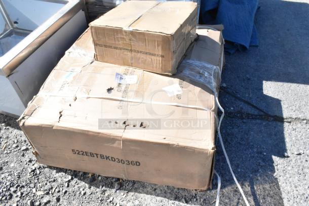 Two scratched and dented boxes containing Steelton 30" x 36" stainless steel table with backsplash and Lancaster 22" table base.