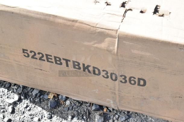 Cardboard box labeled "522EBTBKD3036D" indicating a Steelton stainless steel enclosed base table with a sliding door.
