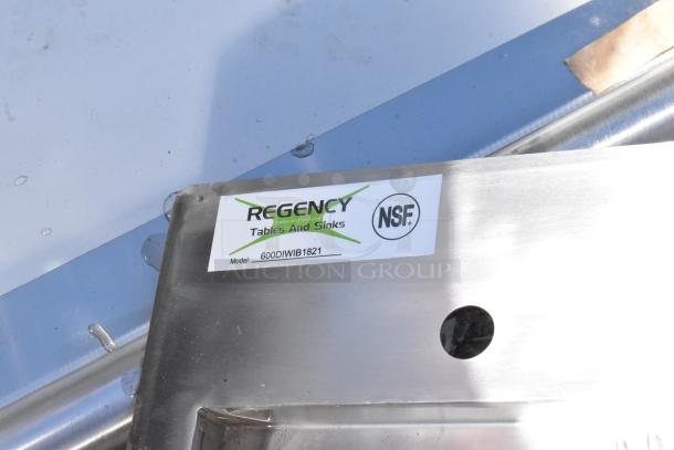 "Regency 600DIWIB1821 stainless steel water station with ice bin, 21x17 inches, featuring NSF label, new condition with minor scratches."
