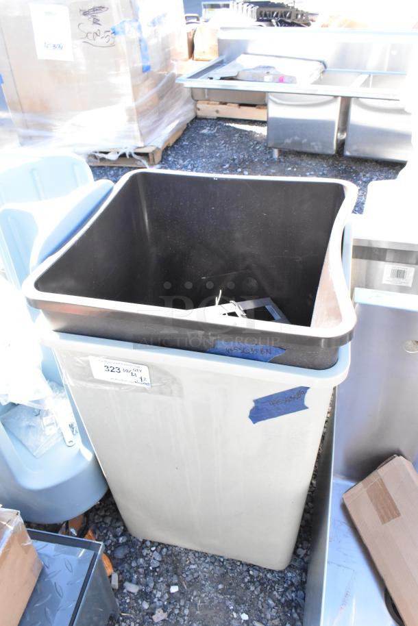 Brand new poly trash can with minor scratches and dents, label marked “323,” high capacity, durable construction.