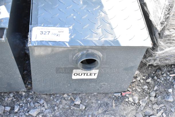 Brand new metal commercial grease trap with light scratches and dents. Features outlet label and auction tag showing "327, 10/21".