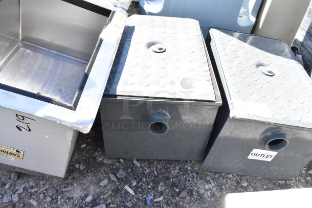 Brand new metal commercial grease trap with minor scratches and dents. Features inlet and outlet labels. Rugged design.