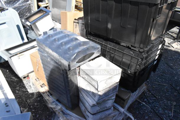 Boxed and stacked catering items, including Visions 10" white plastic plates with gold bands, on a pallet with some plastic wrap.