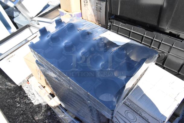 Box of Regency black shelf bins on a pallet. Items inside are sealed in clear plastic. Scratch and dent condition.