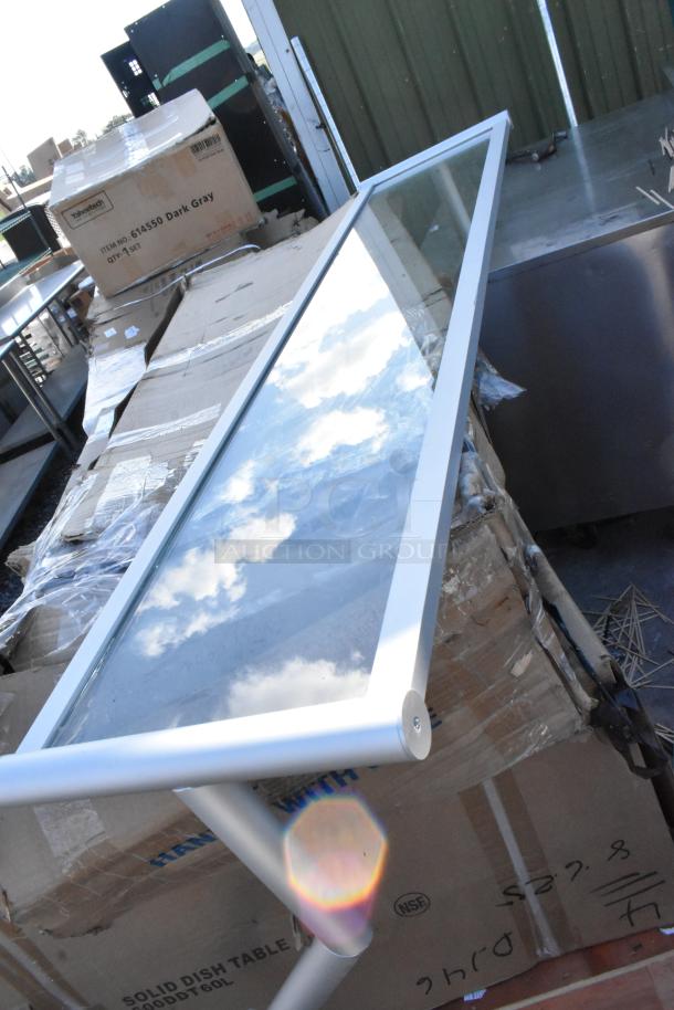 Three brand-new items on pallets, including a Regency 600DDT60L table and Avantco gas griddle box. Items in packaging.