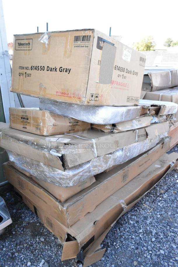 Stack of damaged boxes containing 12 new items, including Yaheetech 614550 dark gray set and other listed pieces.