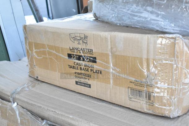 Box marked "Lancaster Table & Seating 22" x 22" Cast Iron Table Base Plate, #164TB2222" with quantity 4, packaged condition.