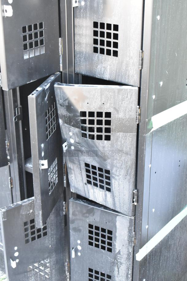 Black metal 12-cubby locker with scratch and dent condition, visible ventilation squares on doors. Some lockers partially open.