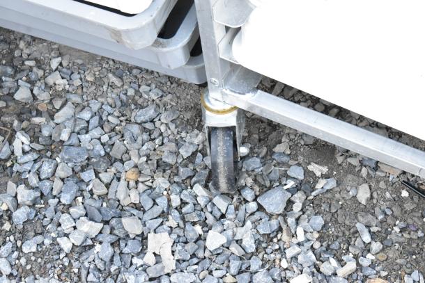 Metal pan transport rack on commercial casters, featuring white poly dough bins. Sturdy and ideal for efficient storage.