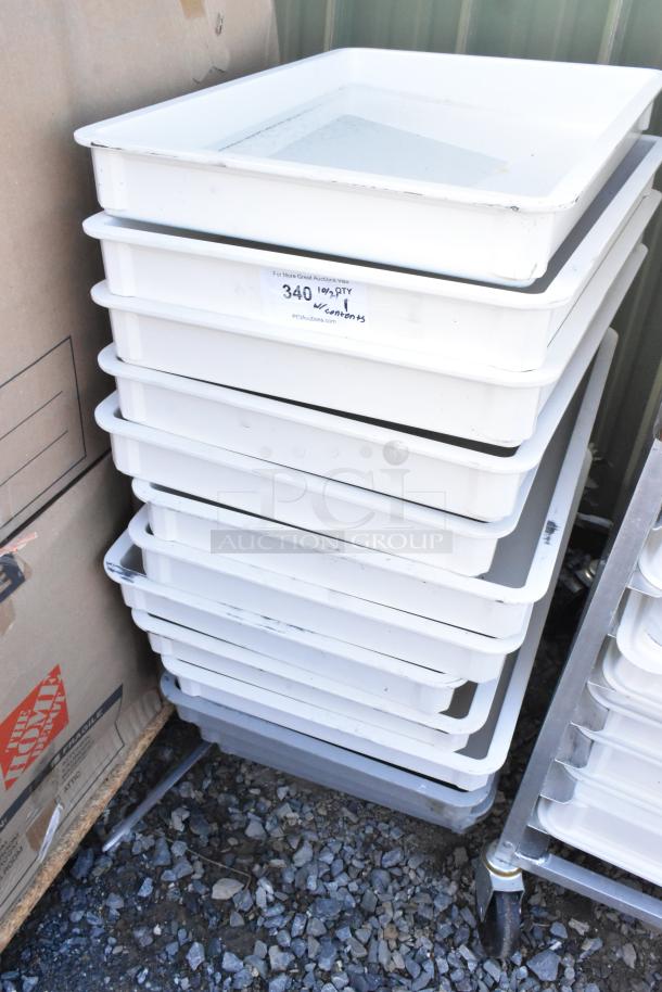 White poly dough bins stacked on a commercial caster dolly, labeled "340" with visible wear, ideal for bulk food storage.
