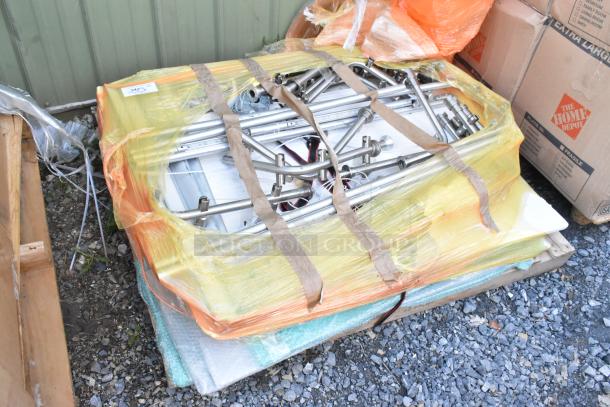 Lot of various stainless steel items, pallet-wrapped with yellow plastic, includes rods and fittings, in fair condition.