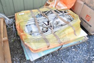 Lot of various stainless steel items, pallet-wrapped with yellow plastic, includes rods and fittings, in fair condition.