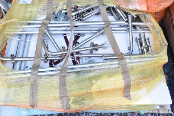 Lot of various items including stainless steel pieces, wrapped in plastic. Items show industrial and hardware components.