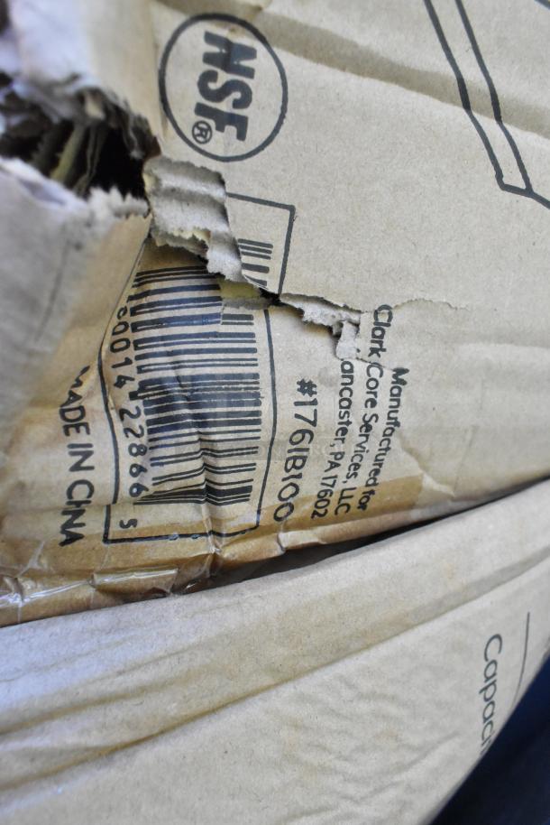 Damaged cardboard box with NSF logo and barcode, marked by Clark Core Services, Lancaster, for auction items.