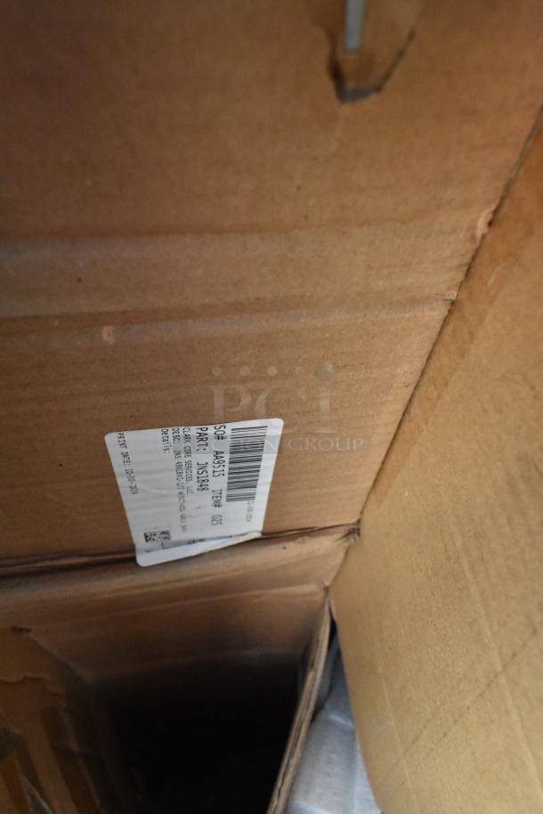 Cardboard box with label showing part number 55548-6. Auction includes new scratch and dent items like ice bagger, sink, and table.
