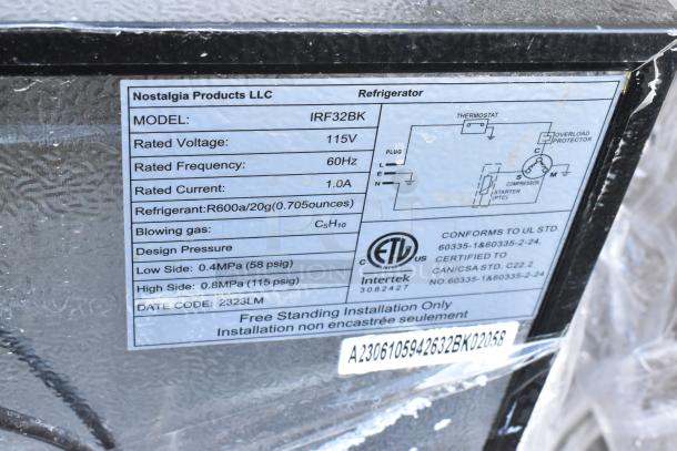 Alt text: Mini cooler label showing Nostalgia IRF32BK model, 115V, 60Hz, R600a refrigerant, certified to UL standards.