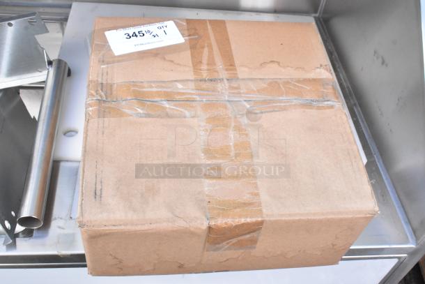 Cardboard box containing 4 commercial casters, sealed with tape. Auction label shows "345", "QTY 1", and PCAuctions.com.