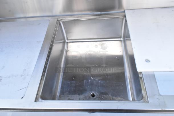 Regency 600PB63B 63" stainless steel portable bar, new with scratches. Includes two removable speed rails and ice bin.
