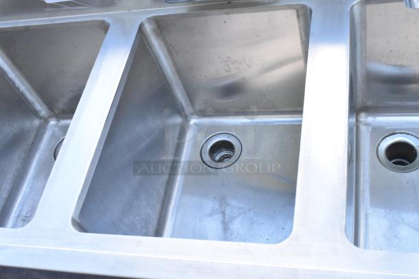 Stainless steel 3-bay back bar sink with right side drain board, faucet, and handles visible. Gently used condition.