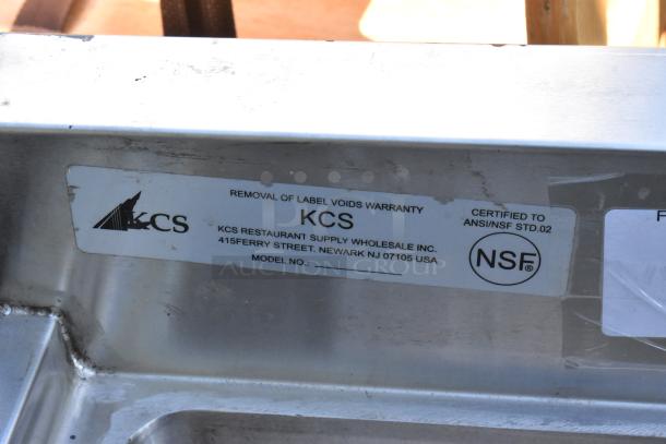 Stainless steel KCS 3 bay back bar sink with right side drain board, faucet, handles; NSF certified, label visible.